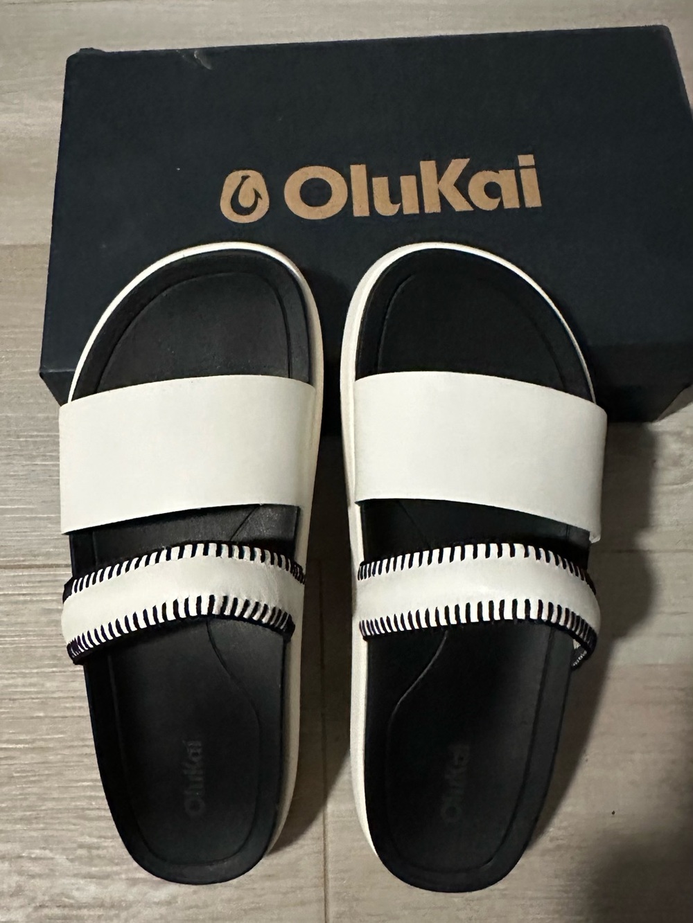 OluKai Two-Band White and Black Slip-On Sandals
